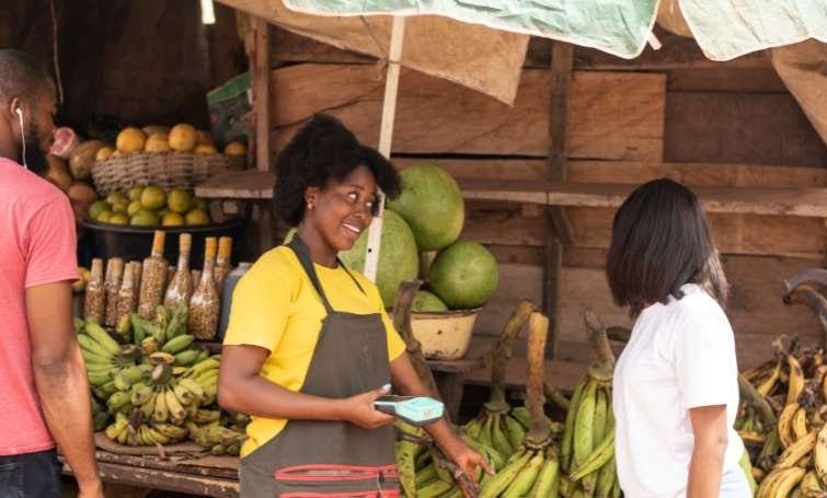 a woman buying to a local business