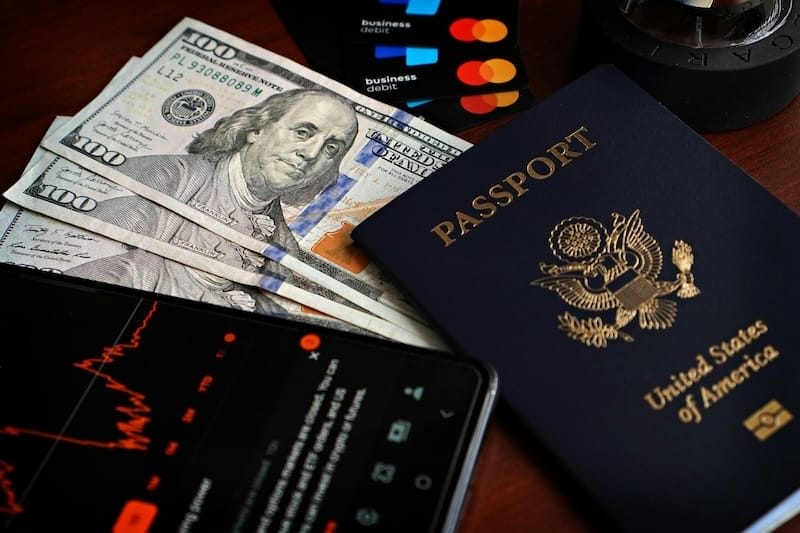 American Passport Privilege - passport, money, credit cards and cellphone on table