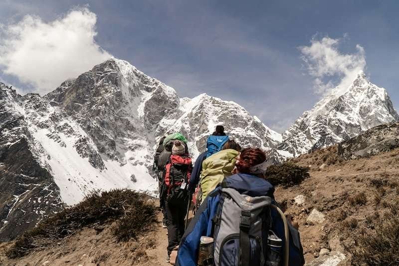 Backpackers trek a mountain
